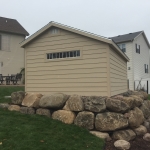 Slab  poured on top or boulder retaining wall